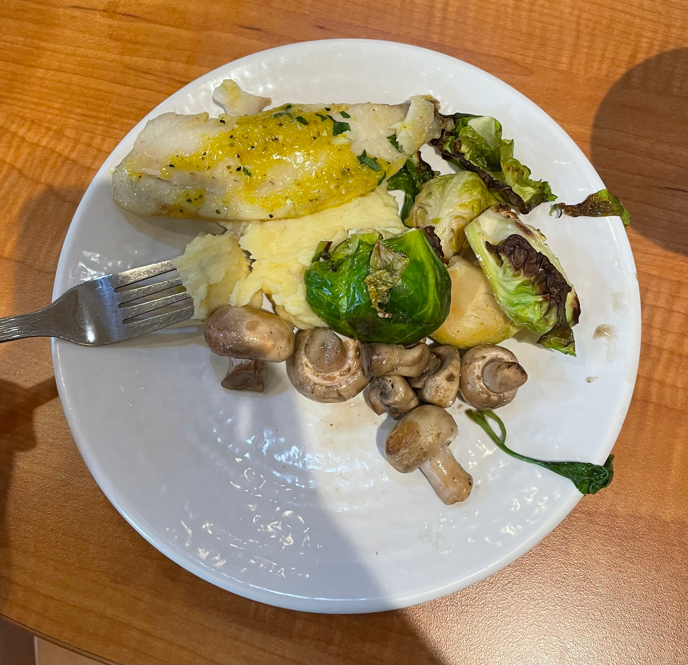Fish, mashed potatoes, brussel sprouts, and mushrooms