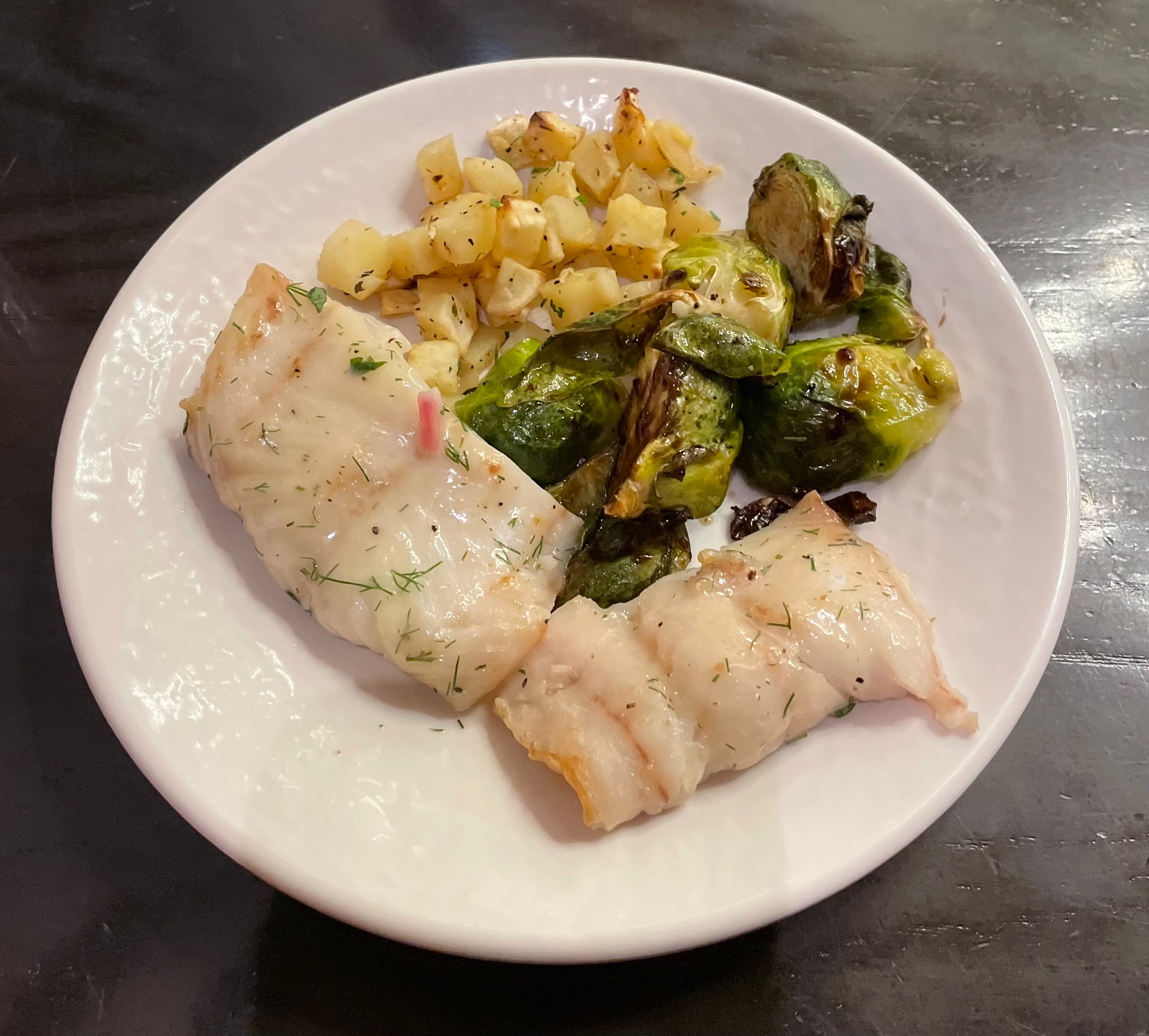Fish, brussel sprouts, and potato cubes