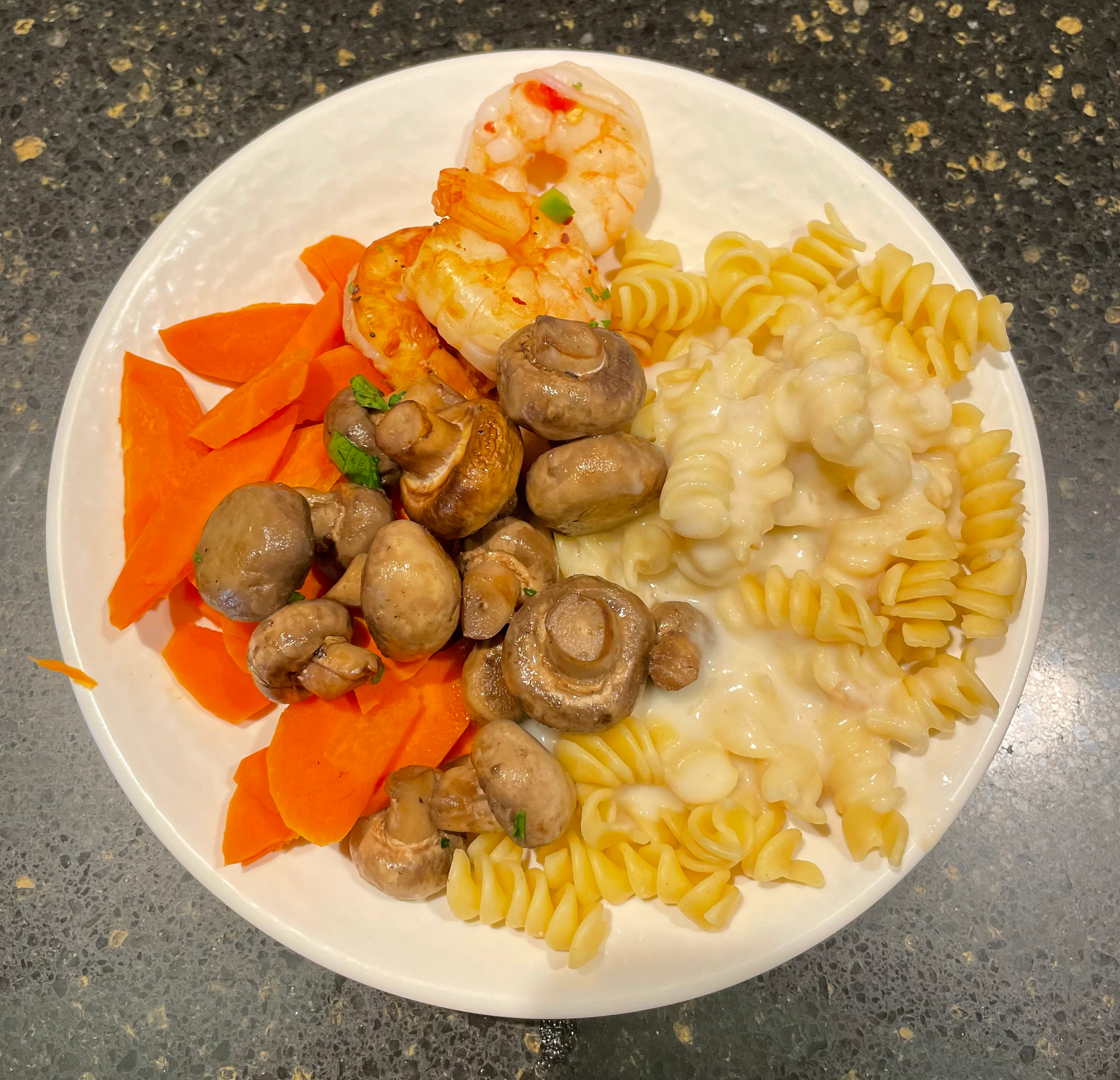 Pasta with alfredo sauce, mushrooms, carrots, shrimp